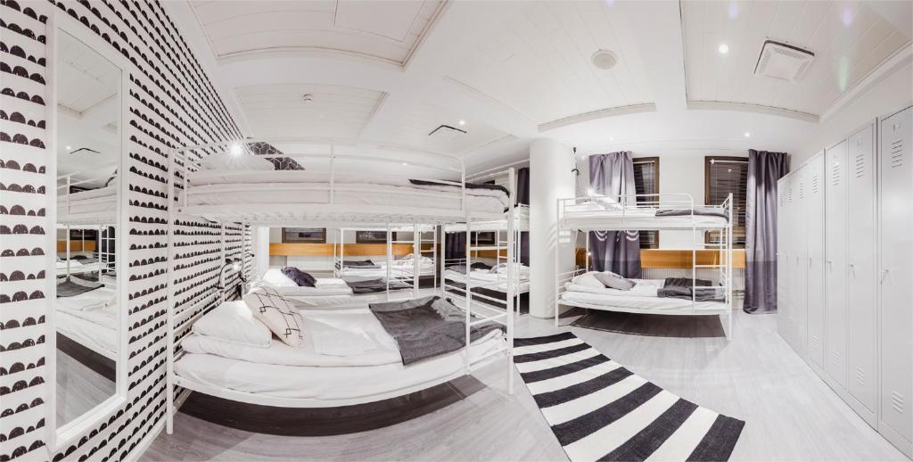 a room with four bunk beds in it at Hostel Café Koti in Rovaniemi