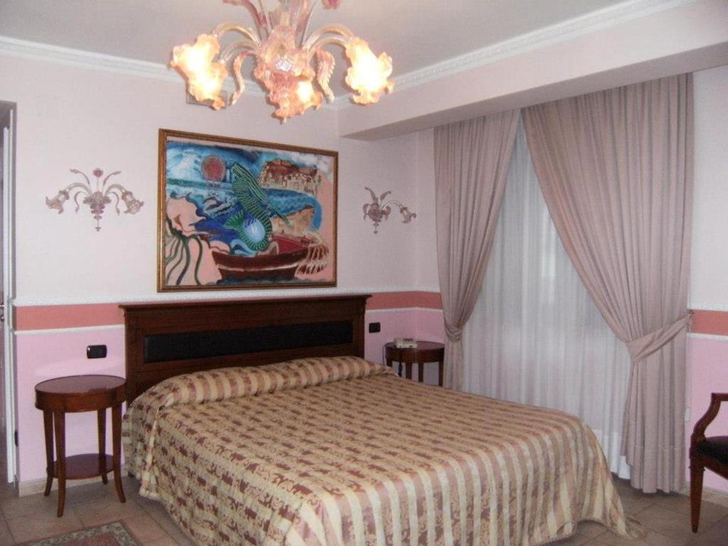 Postel nebo postele na pokoji v ubytování Hotel U' Bais