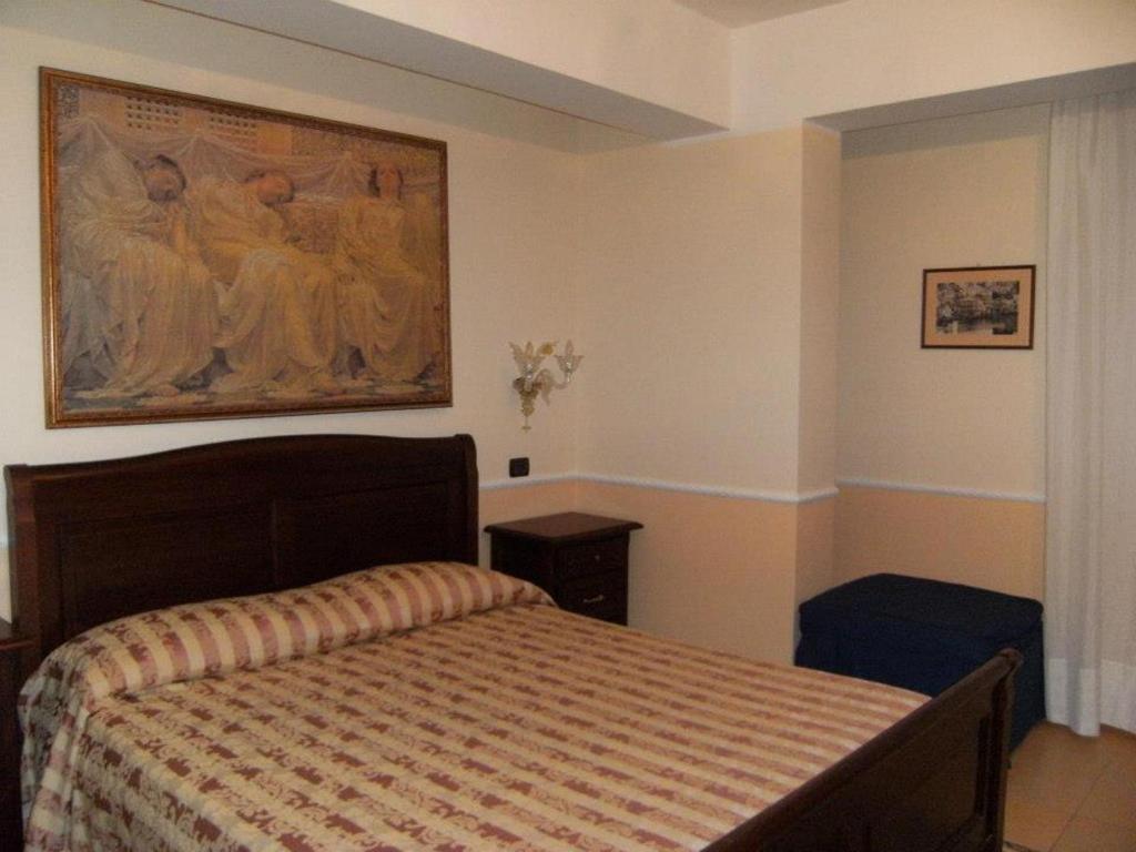 Postel nebo postele na pokoji v ubytování Hotel U' Bais