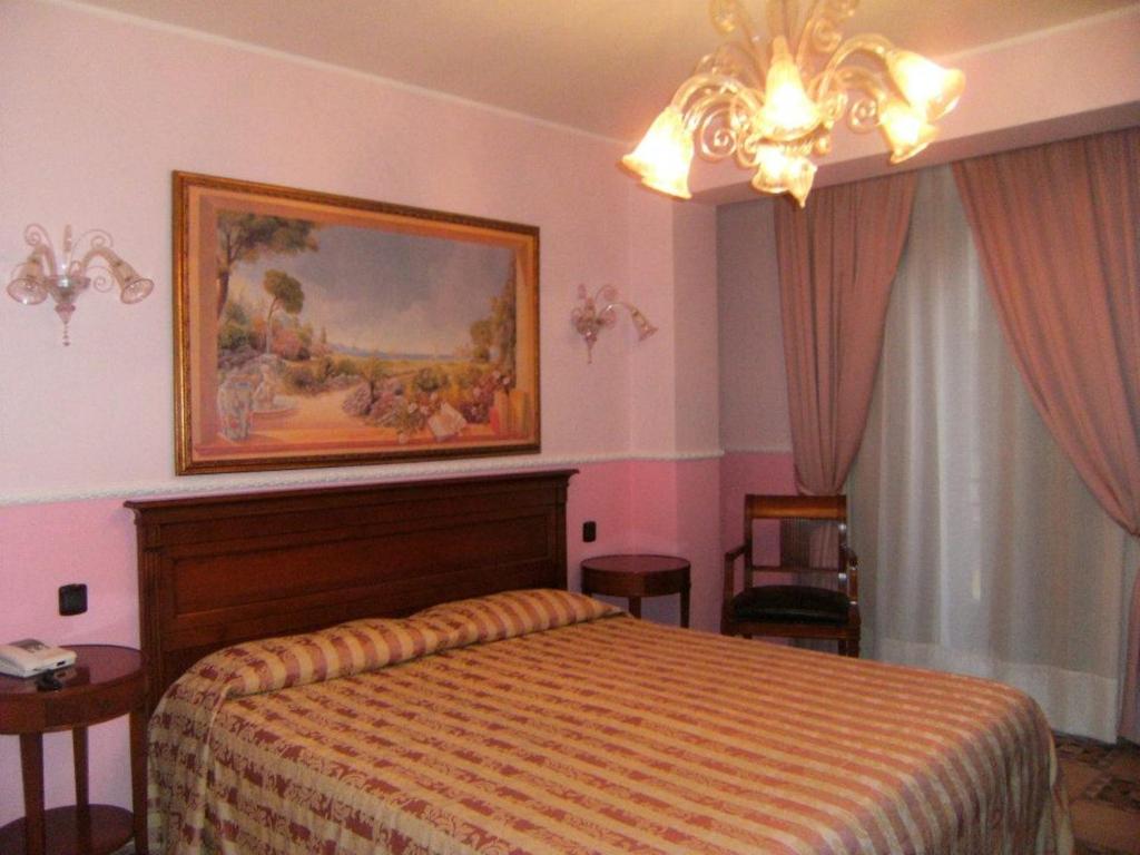 Postel nebo postele na pokoji v ubytování Hotel U' Bais