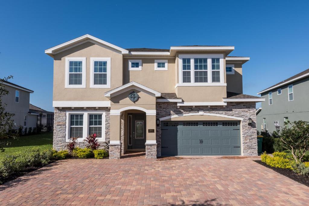 a house with a brick driveway at Fabulous Home by Rentyl Near Disney with Private Pool, Movie Room, Themed Rooms & Resort Amenities at Encore Resort - 360B in Orlando