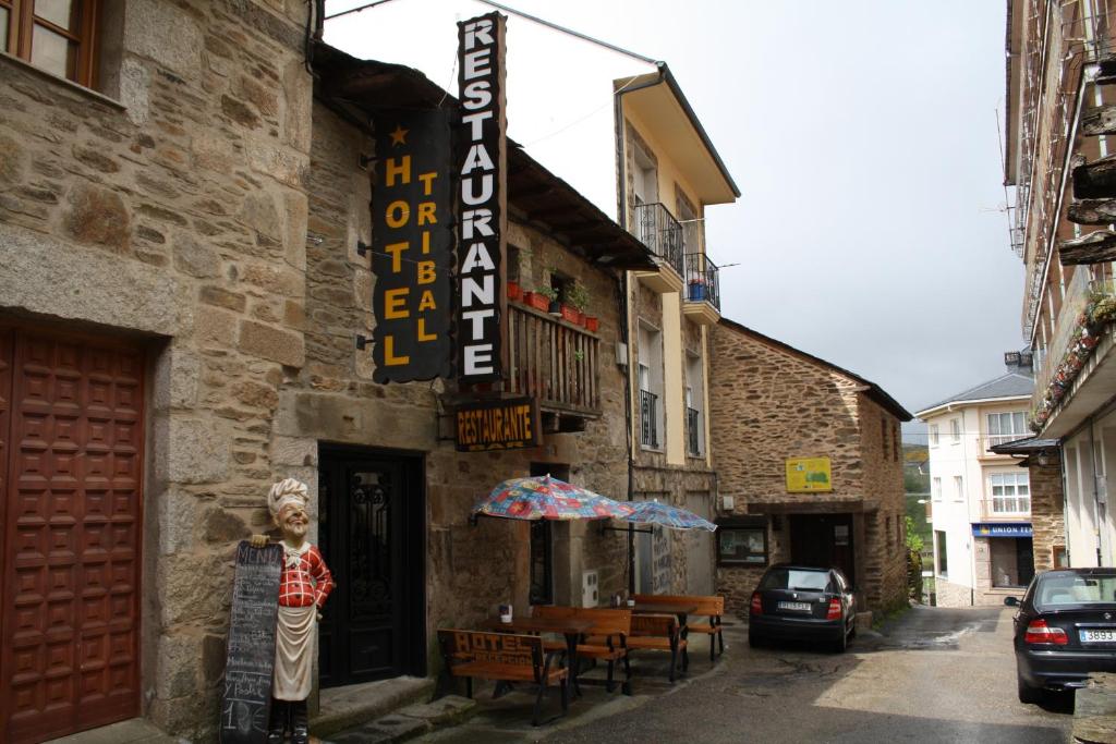 a building with a sign on the side of it at Hostal Tribal in Puebla de Sanabria