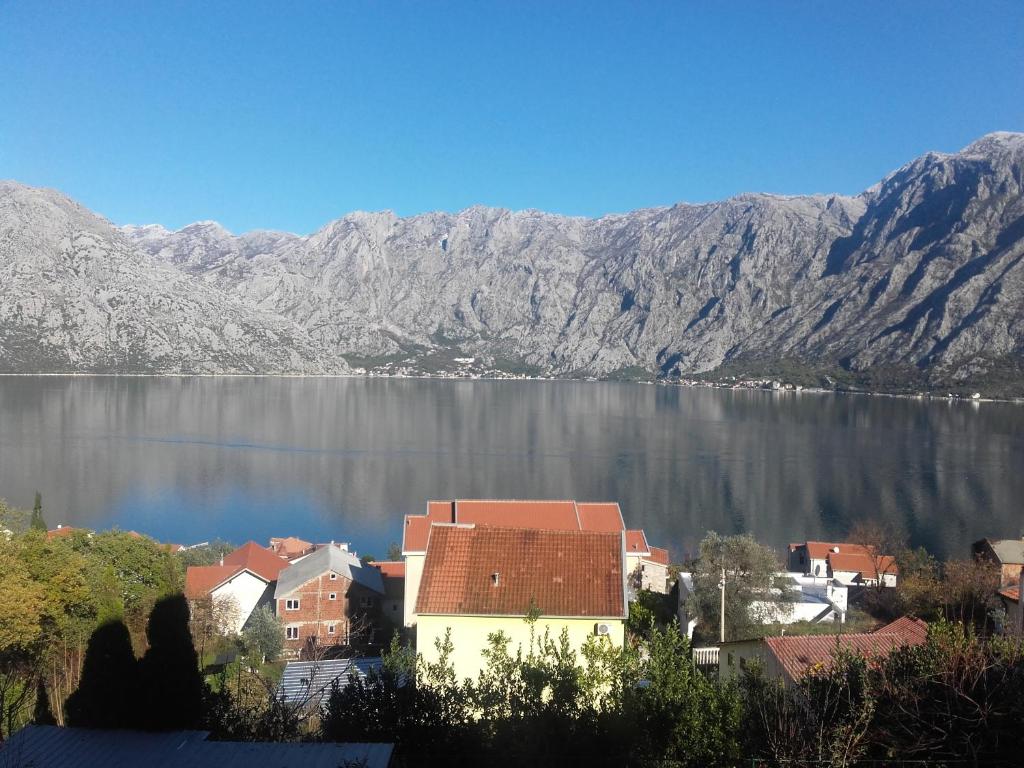 a town in front of a body of water with mountains at Apartment Marija in Kotor