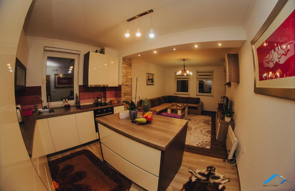 a kitchen and living room with a counter top at Sweet Apartment in Bihać