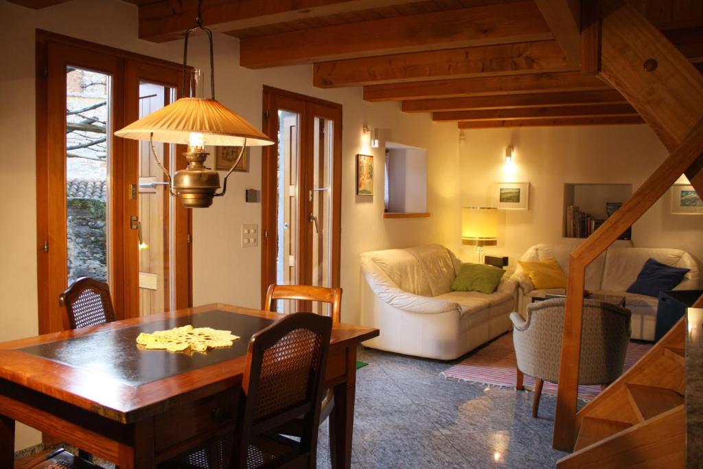 a living room with a table and a couch at Tenuta Casa Cima - tenutacasacima com - in Gudo