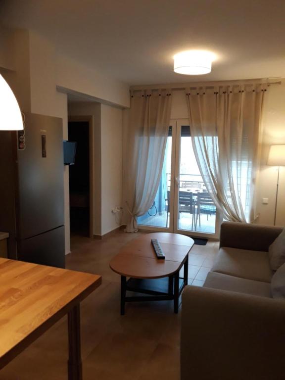 a living room with a couch and a table at Τhe Diamond in Nea Peramos