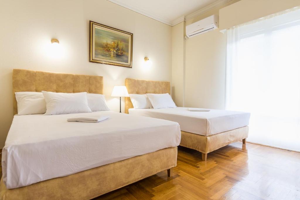 Postel nebo postele na pokoji v ubytování Victoria Queens Paradise Apartments
