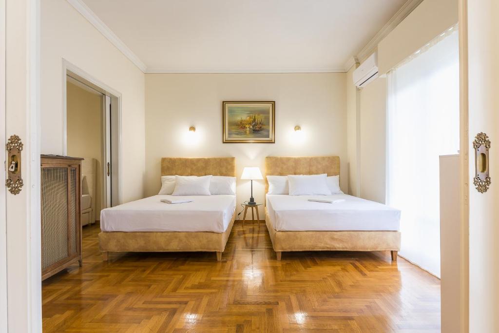 Postel nebo postele na pokoji v ubytování Victoria Queens Paradise Apartments