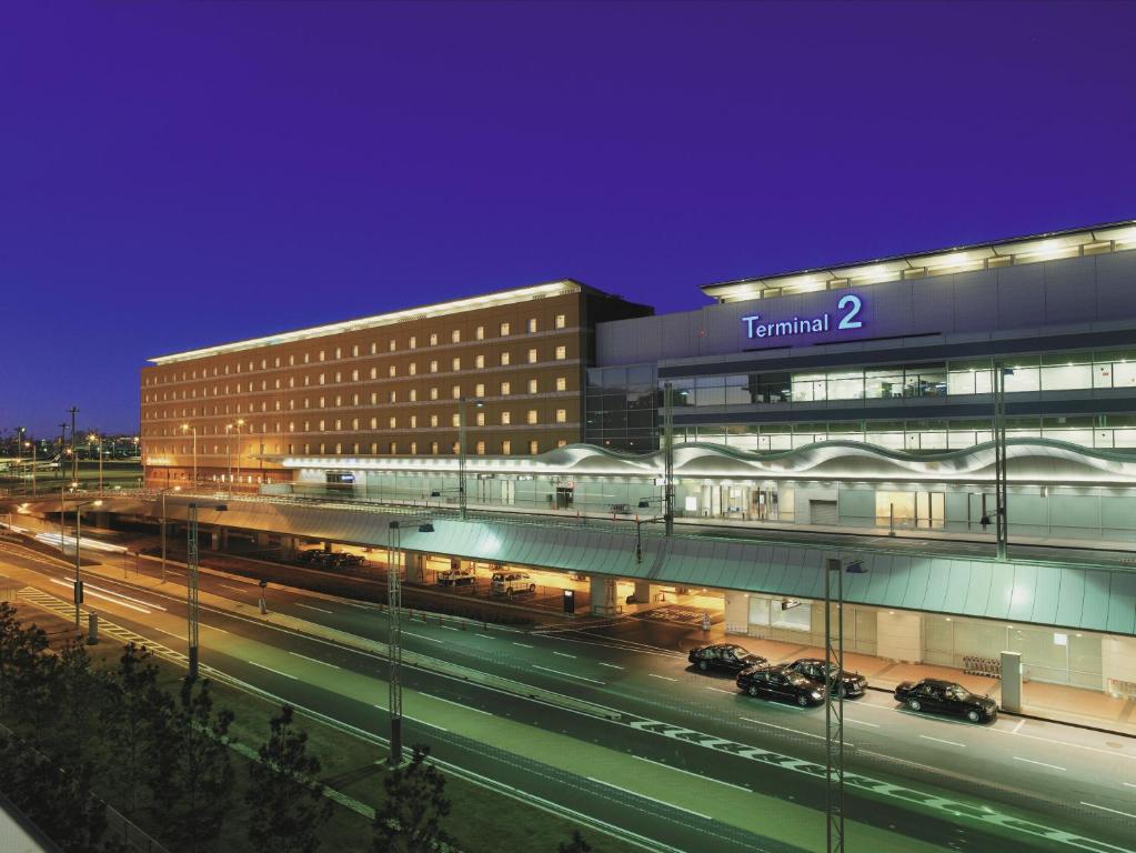 a building with a train in front of it at night at Haneda Excel Hotel Tokyu Haneda Airport Terminal 2 in Tokyo