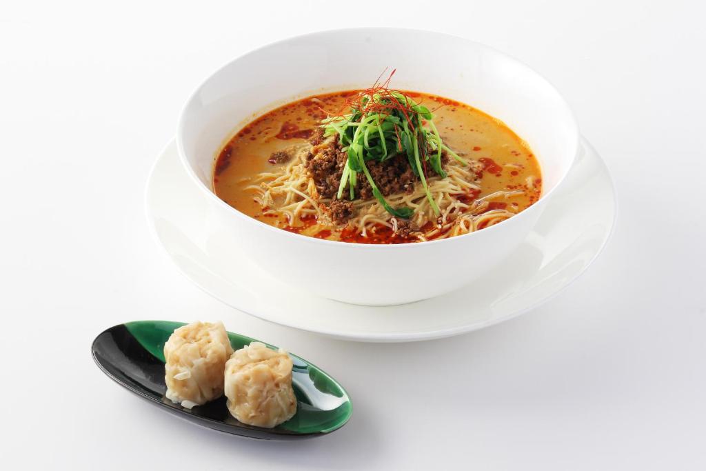 a bowl of soup and a plate of dumplings at Haneda Excel Hotel Tokyu Haneda Airport Terminal 2 in Tokyo