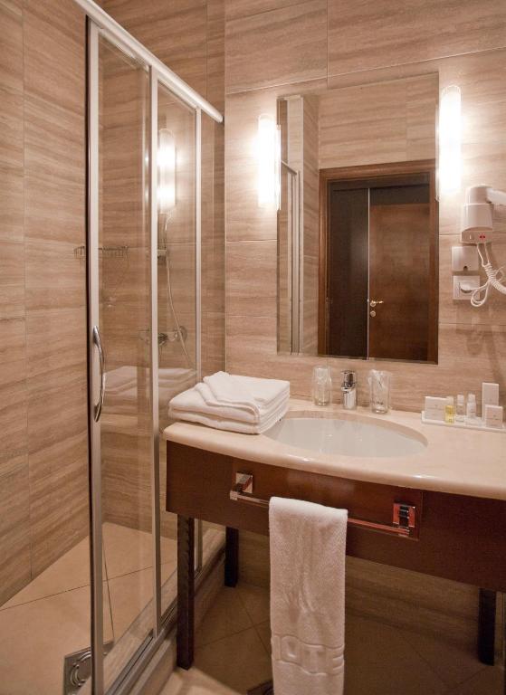 a bathroom with a sink and a shower at Manjež Centar in Belgrade