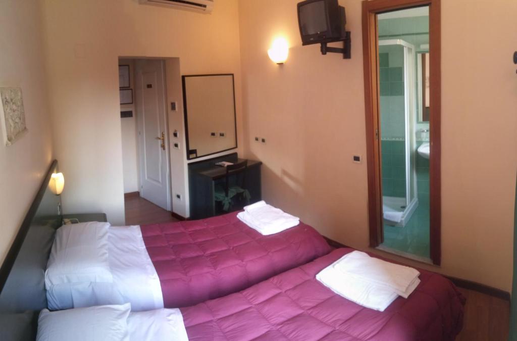 Postel nebo postele na pokoji v ubytování Hotel Prati