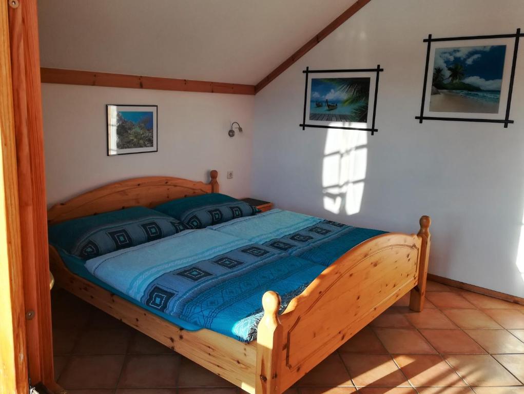 a bedroom with a wooden bed in a room at Blockhaus Royer in Ramsau am Dachstein