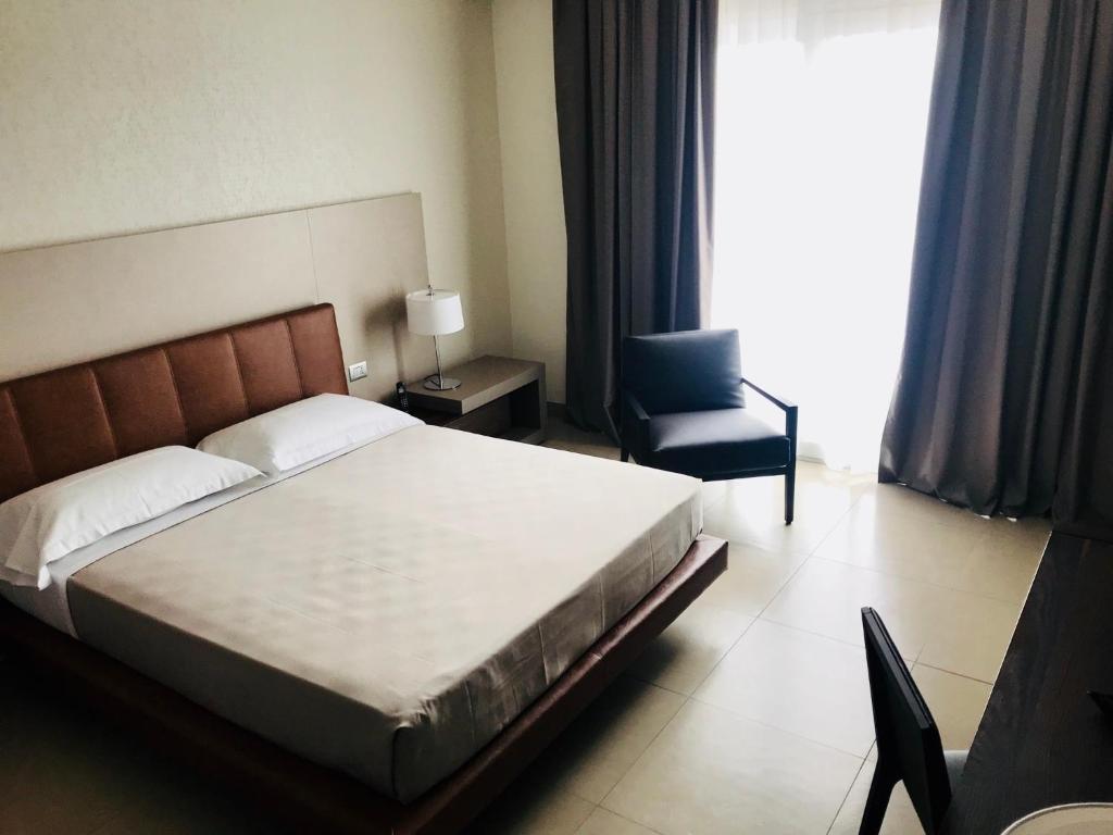 Postel nebo postele na pokoji v ubytování Hotel Vespucci