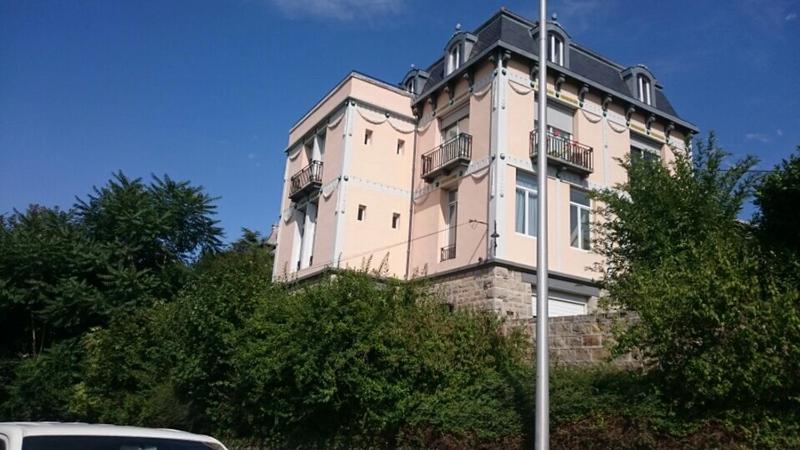 a tall building on top of some trees at Demeure des Dentelles in Le Puy-en-Velay