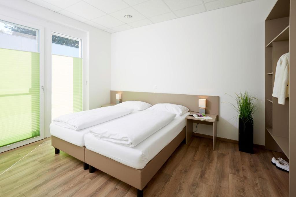 Postel nebo postele na pokoji v ubytování Good Rooms GmbH Guntramsdorf