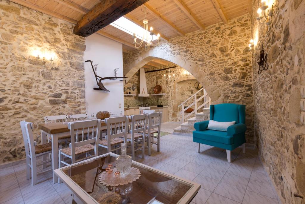 a room with a table and chairs in a stone building at Trigono Kaliviani, 4BDR - 3BR - 8 people in Kissamos