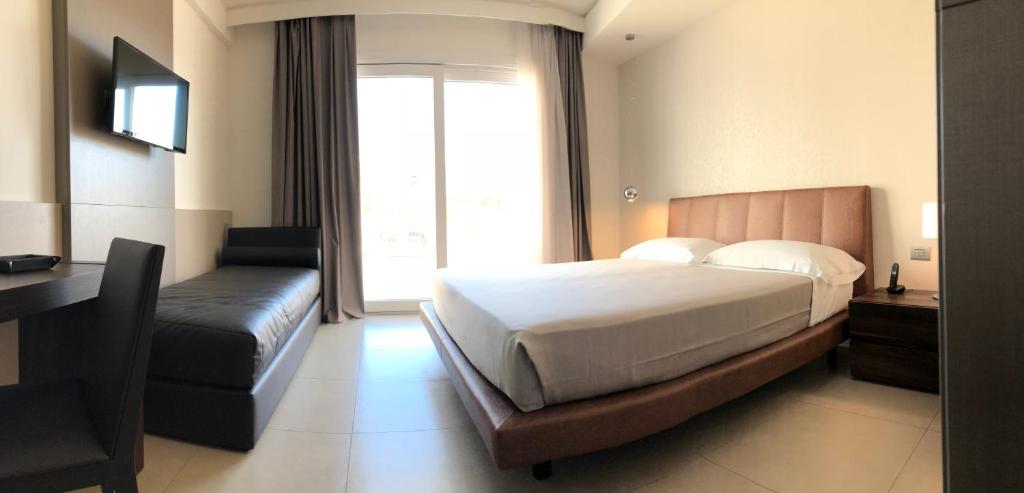 Postel nebo postele na pokoji v ubytování Hotel Vespucci