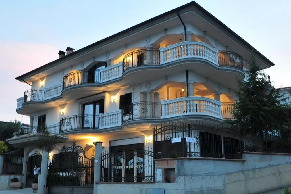a large white building with balconies on it at B&B Rosa dei Venti in Roseto Capo Spulico