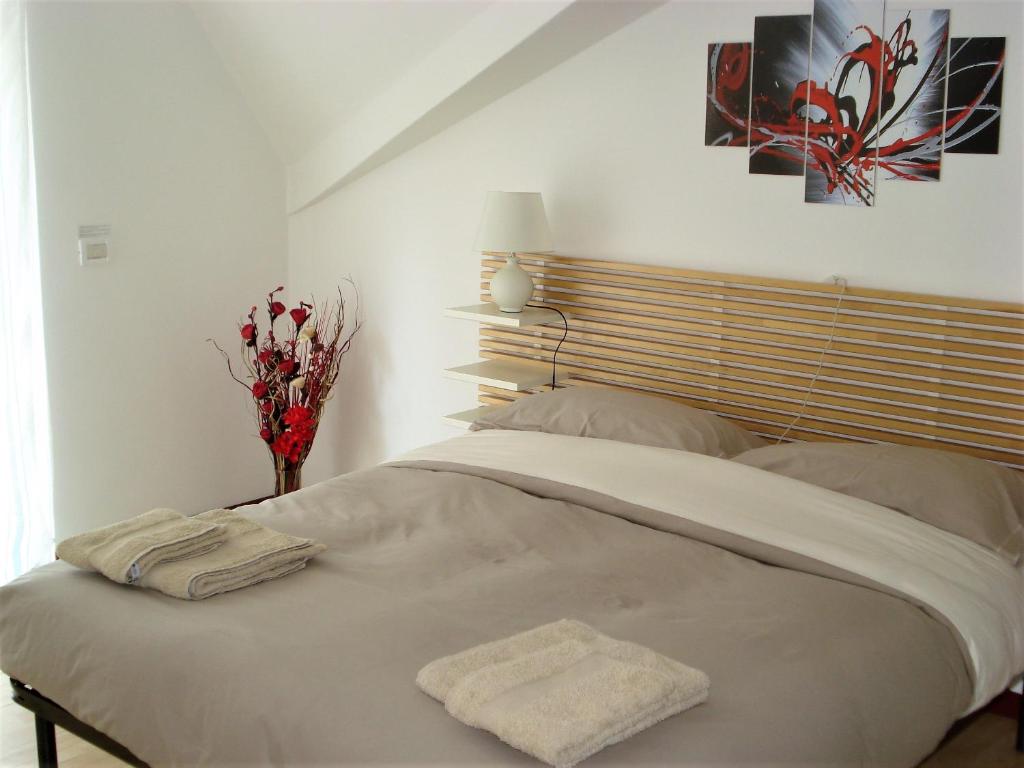 a bed with two towels on it in a bedroom at Boschetto in Riva del Garda