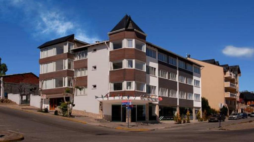 a large apartment building on the corner of a street at Monte Cervino Hotel in San Carlos de Bariloche