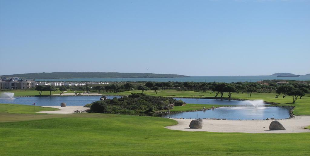 a lake with a large body of water surrounded by trees at Langebaan Country Estate in Langebaan