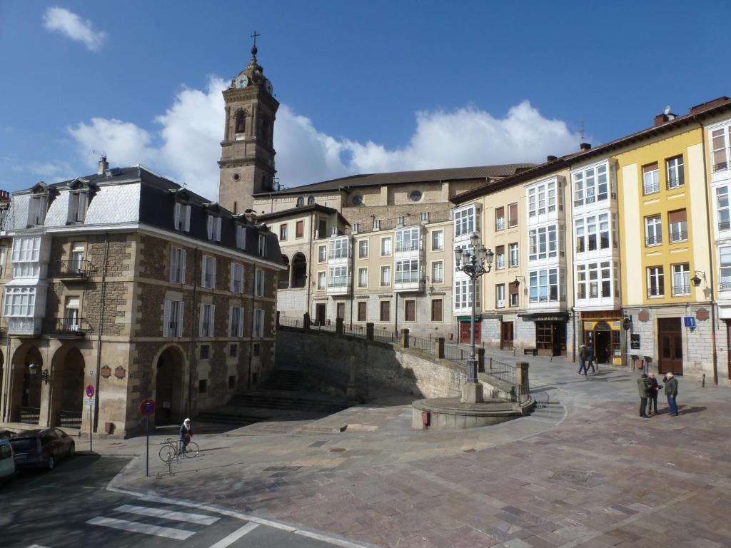 a group of buildings in a city with a clock tower at Hostal del Arquitecto in Vitoria-Gasteiz