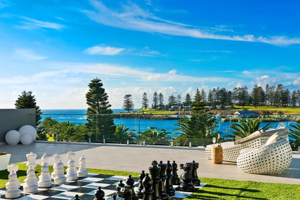 a chess board on the lawn with a view of the ocean at Belle Vue- Penthouse at Black Beach in Kiama