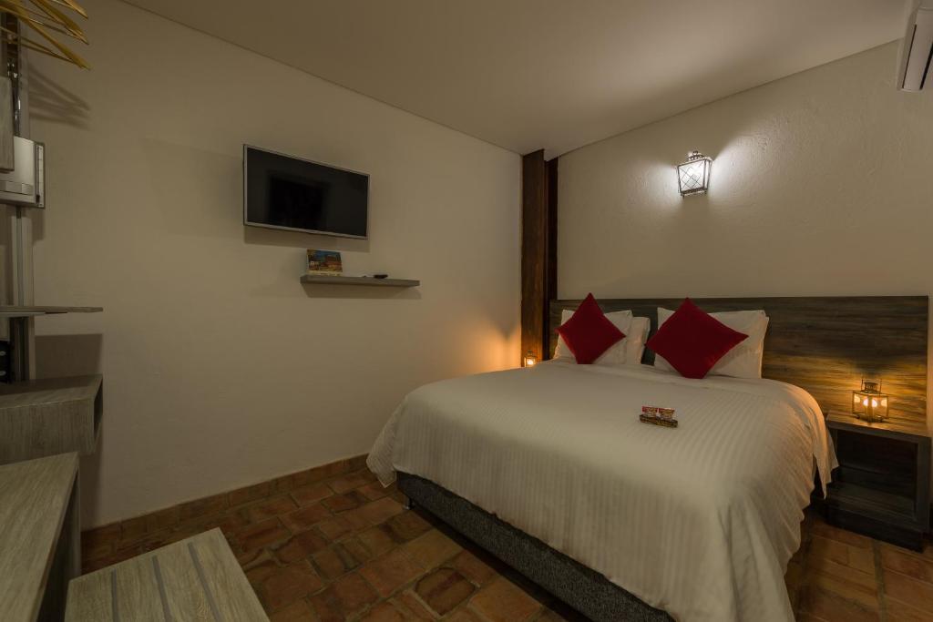 Postel nebo postele na pokoji v ubytování Getsemani Cartagena Hotel