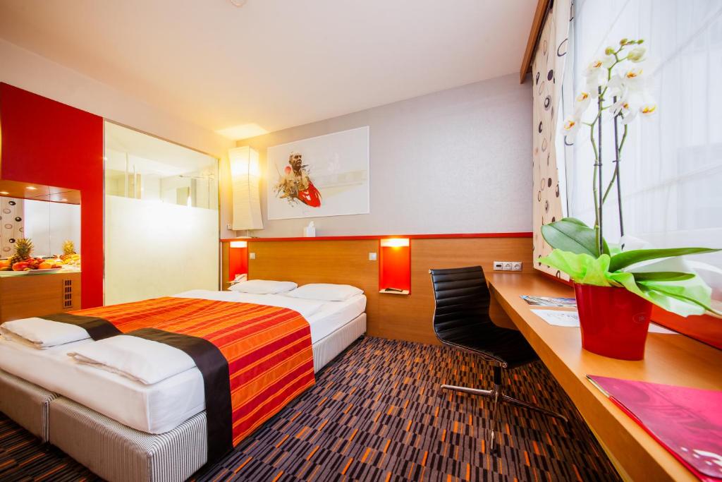 A bed or beds in a room at Royal Park Boutique Hotel