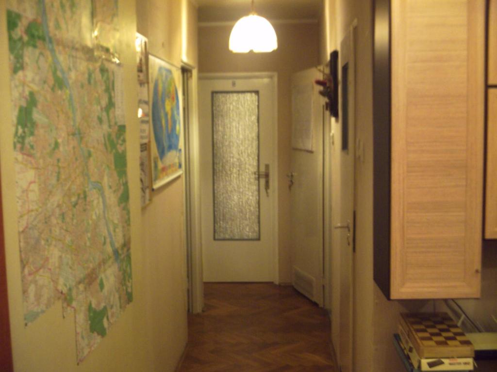 a hallway with a door and a map on the wall at U Rafcia in Warsaw