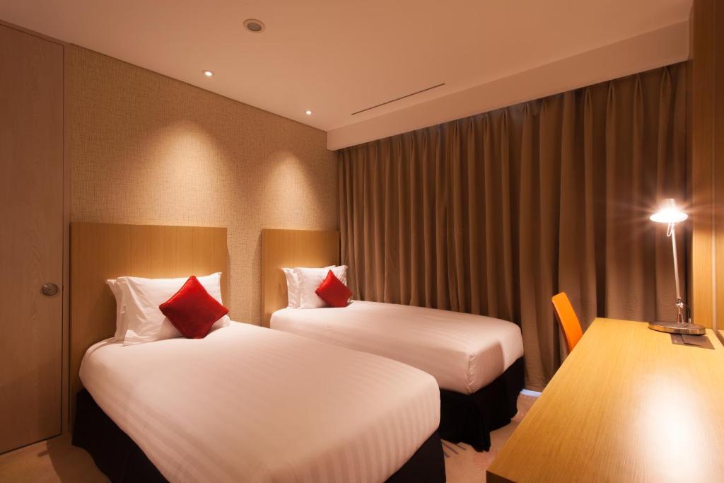 Postel nebo postele na pokoji v ubytování Solaria Nishitetsu Hotel Busan