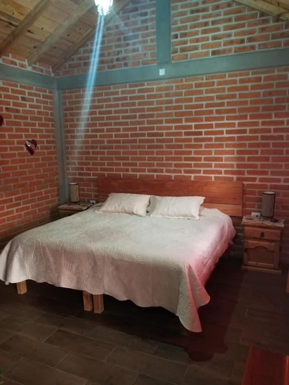 Postel nebo postele na pokoji v ubytování Cabañas villa de San Miguel