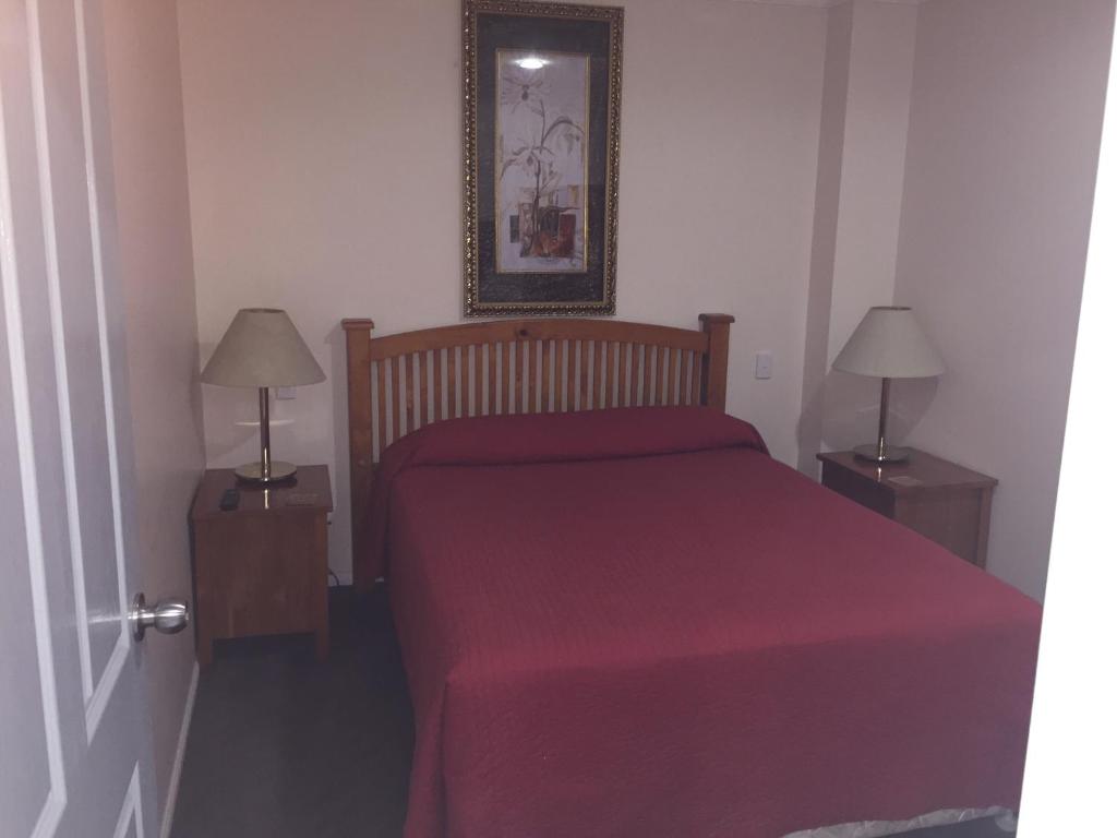 a bedroom with a bed and a dresser at Westside Tavern & Motel in Maryborough