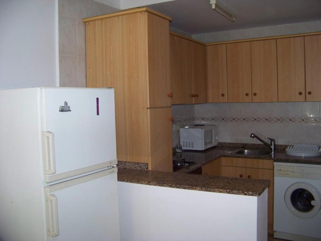 A kitchen or kitchenette at Apartamentos Chelo
