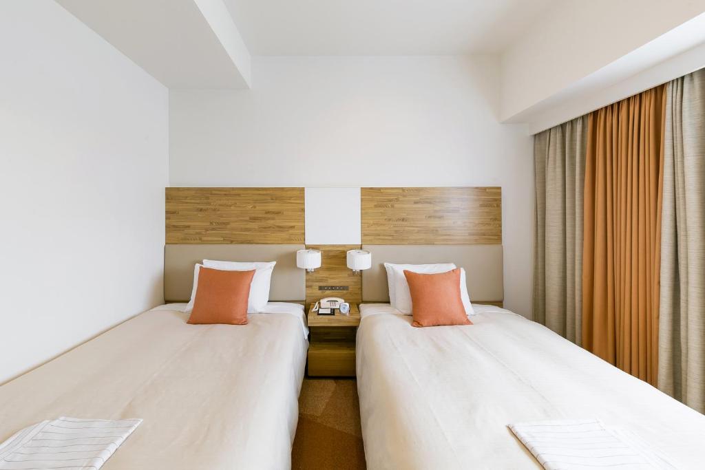 Postel nebo postele na pokoji v ubytování Sotetsu Fresa Inn Nagano-Zenkojiguchi