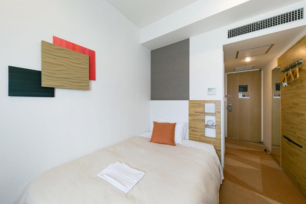 Postel nebo postele na pokoji v ubytování Sotetsu Fresa Inn Nagano-Zenkojiguchi