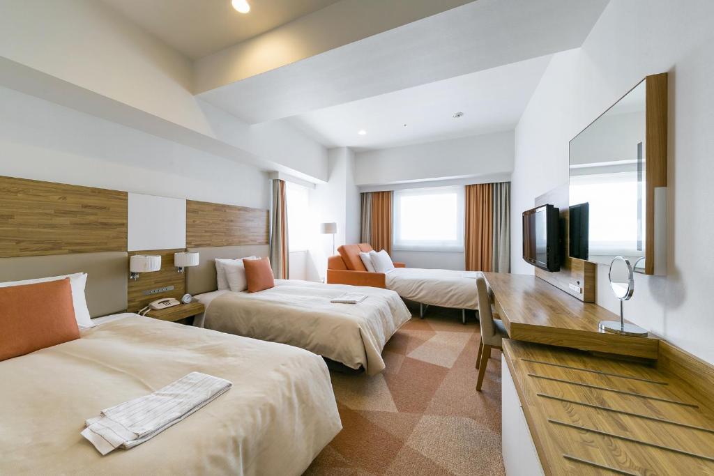 Postel nebo postele na pokoji v ubytování Sotetsu Fresa Inn Nagano-Zenkojiguchi