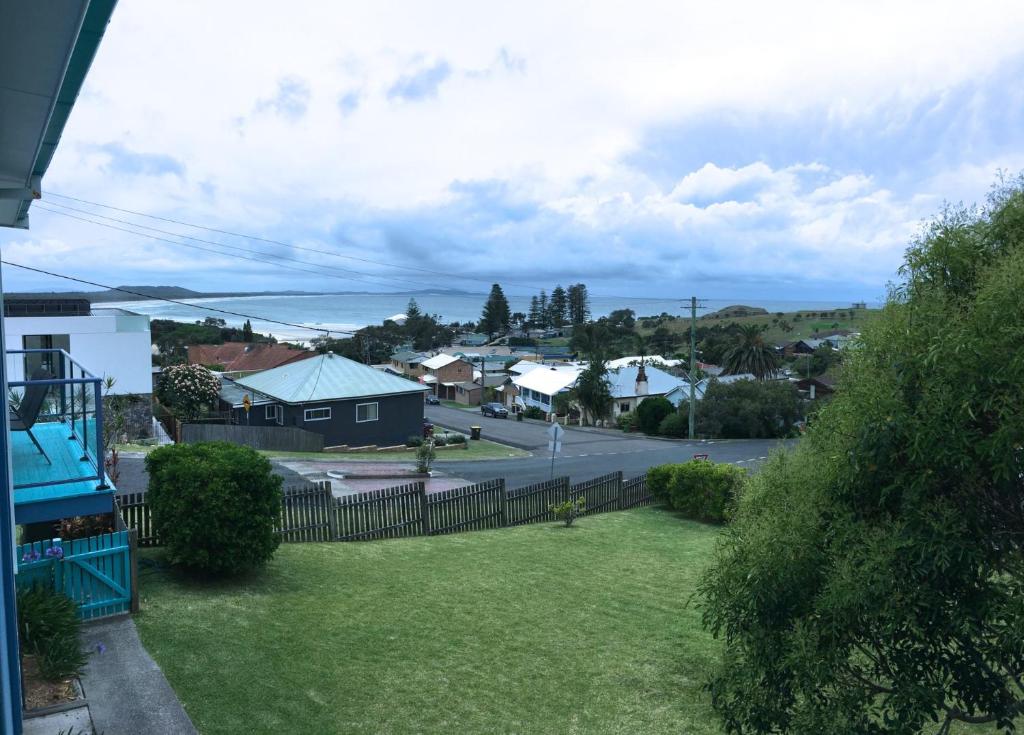 a view of a yard with a fence and houses at Clareview, 8 Korogora Street in Crescent Head