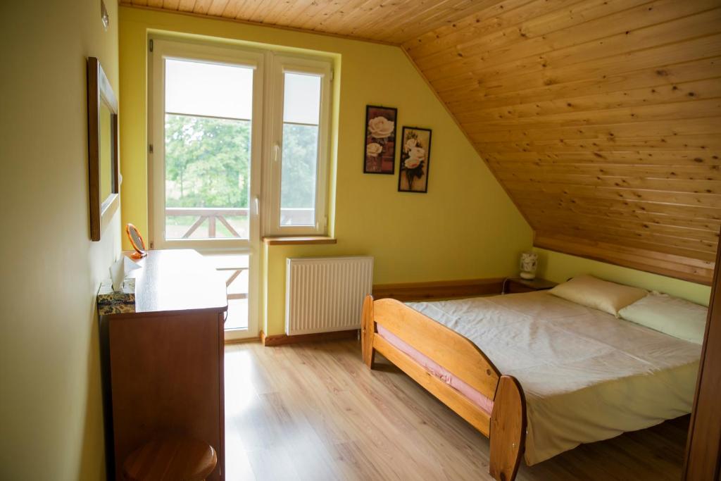Postel nebo postele na pokoji v ubytování Agroturystyka Ogrodniki