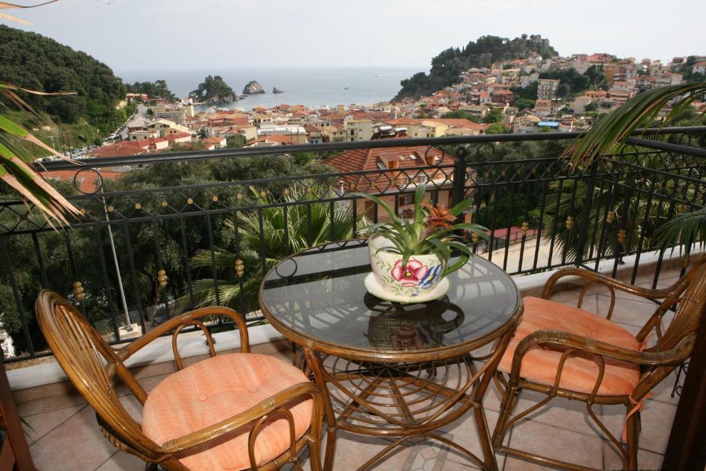 a table and chairs on a balcony with a view at Katsios Studios in Parga