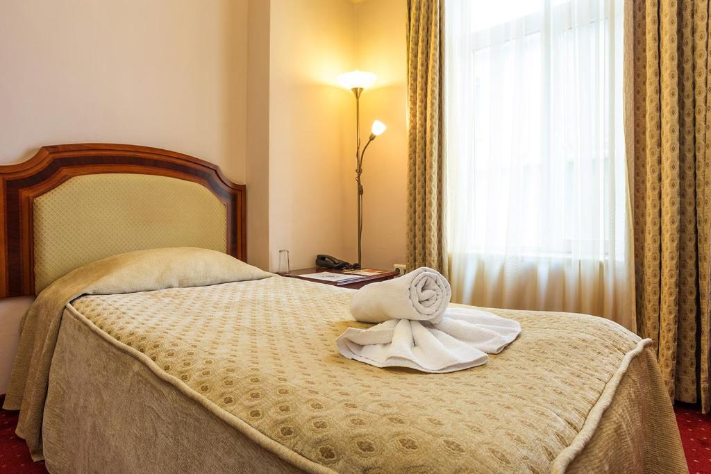 Postel nebo postele na pokoji v ubytování Boutique Splendid Hotel