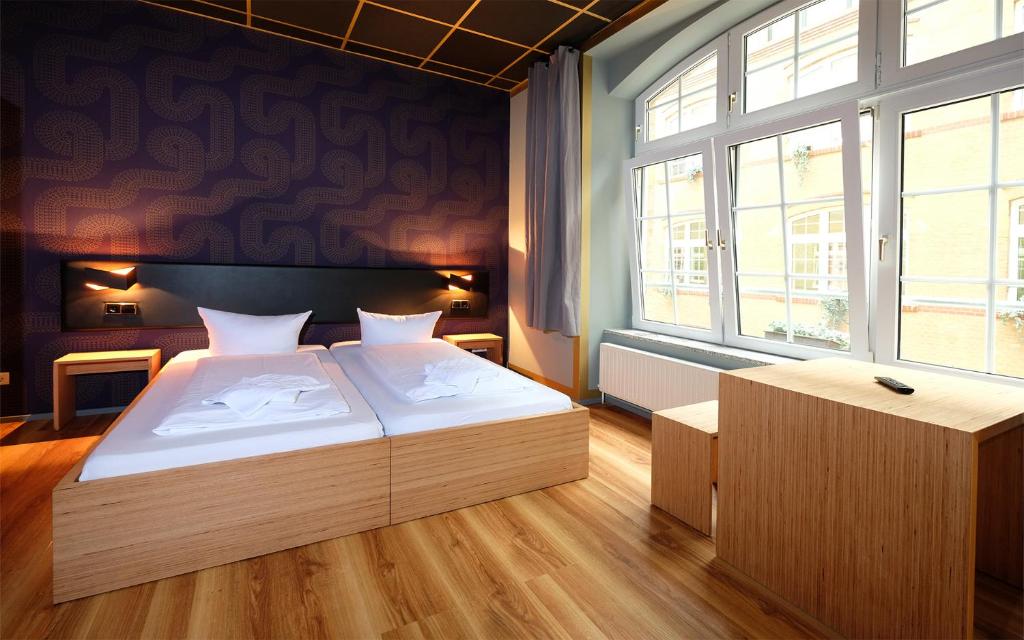 Postel nebo postele na pokoji v ubytování Singer109 Hostel, Hotel & Apartment
