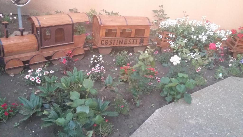 a toy train in a garden with flowers at Ionela in Costinesti