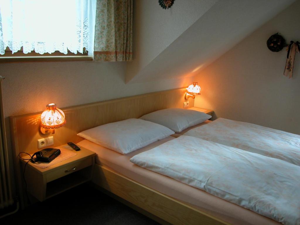 A bed or beds in a room at Haus Dorfer