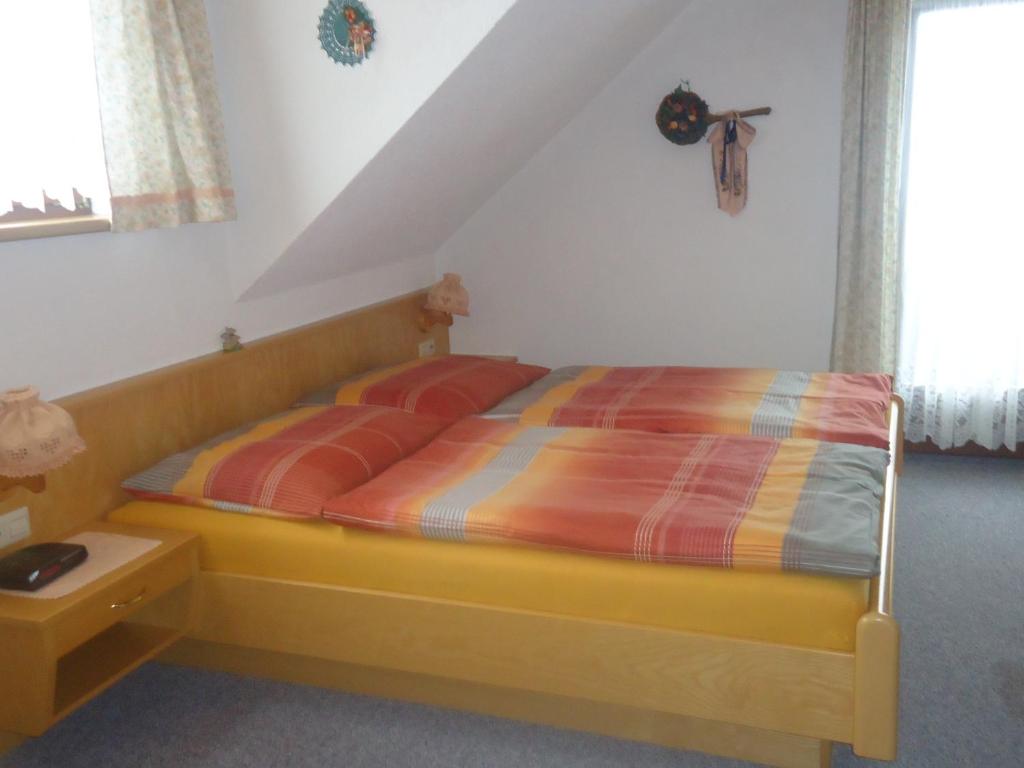 A bed or beds in a room at Haus Dorfer