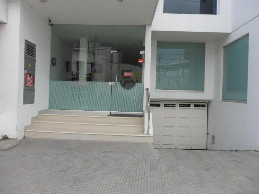 a store front with a glass door and stairs at Hotel Ginebra Sincelejo in Sincelejo