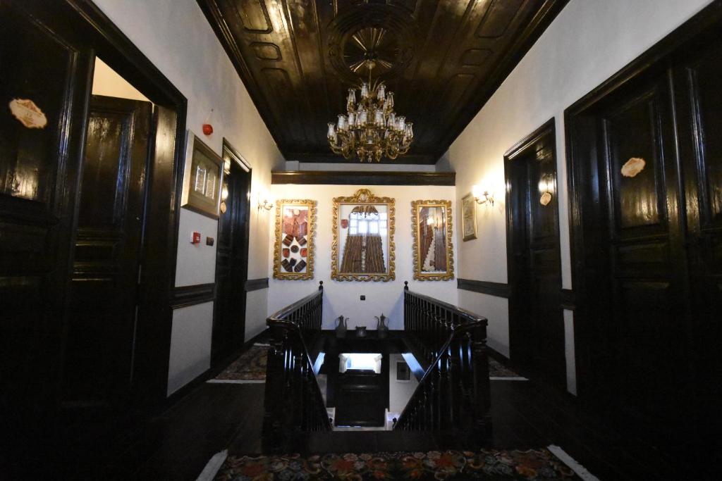 a hallway with a chandelier and a table in a building at Edirne Osmanlı Evleri in Edirne