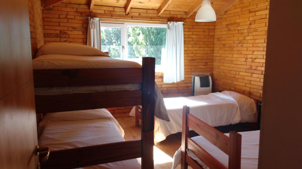 a room with two bunk beds and a window at Apart Dry Fly in Junín de los Andes
