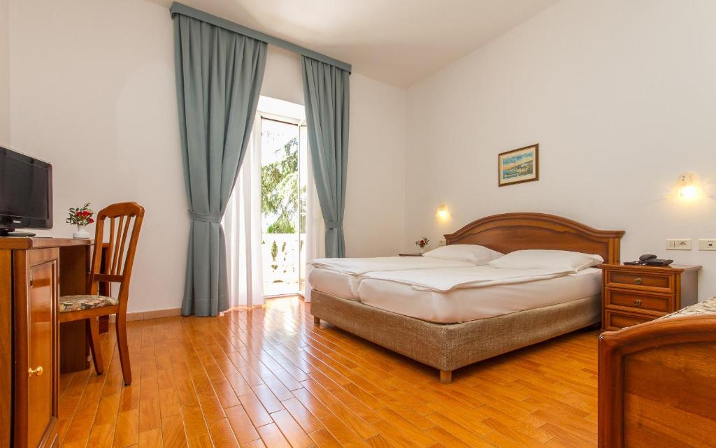 Postel nebo postele na pokoji v ubytování Hotel Marko